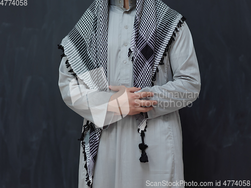 Image of Portrait of young muslim man wearing traditional clothes