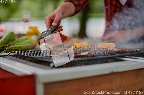 Image of man cooking tasty food for french dinner party