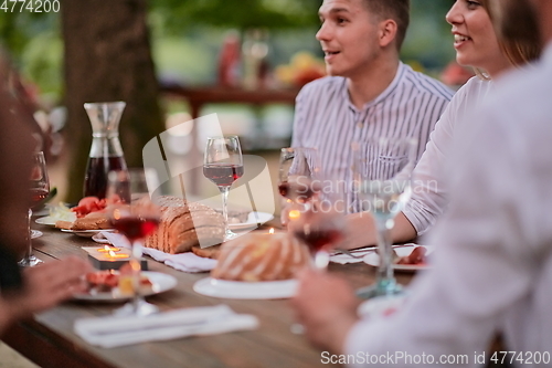 Image of friends having picnic french dinner party outdoor during summer holiday