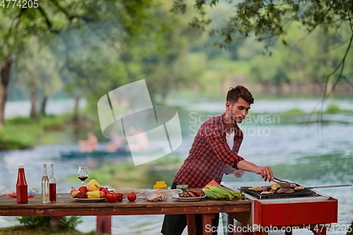 Image of man cooking tasty food for french dinner party