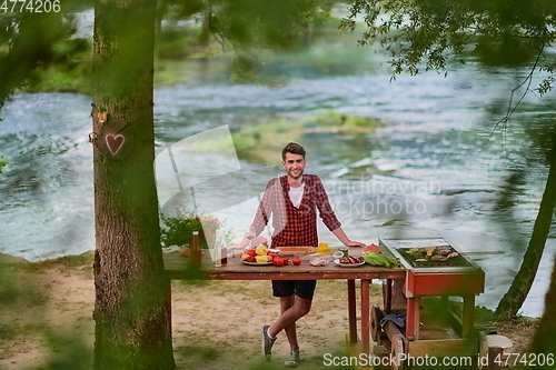 Image of man cooking tasty food for french dinner party