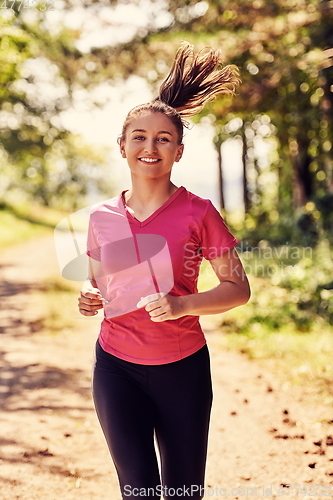 Image of woman enjoying in a healthy lifestyle while jogging