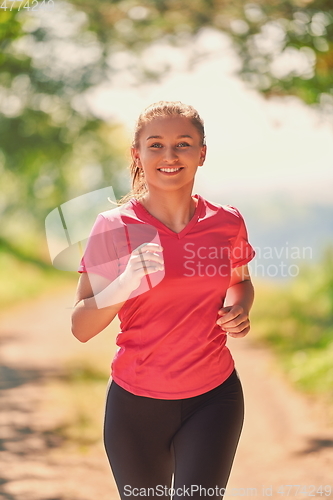 Image of woman enjoying in a healthy lifestyle while jogging