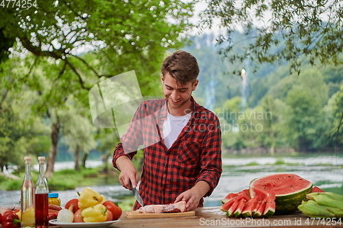 Image of man cooking tasty food for french dinner party