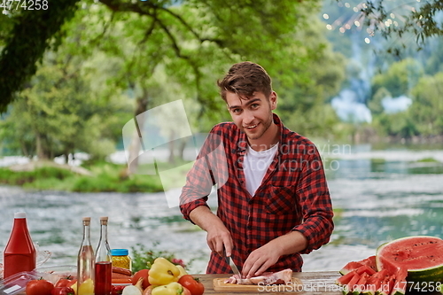 Image of man cooking tasty food for french dinner party