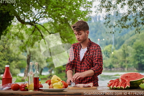 Image of man cooking tasty food for french dinner party