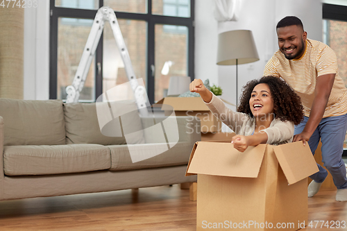 Image of happy couple moving to new home and having fun