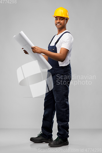 Image of happy indian builder in helmet with blueprint