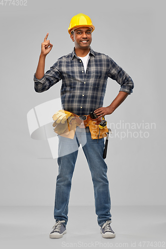 Image of happy indian builder in helmet with tool belt