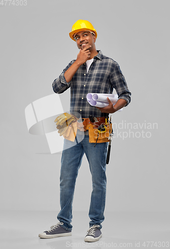 Image of happy indian builder in helmet with blueprints