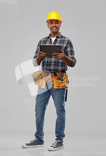 Image of happy indian builder in helmet with tablet pc