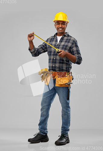 Image of happy indian worker or builder with ruler