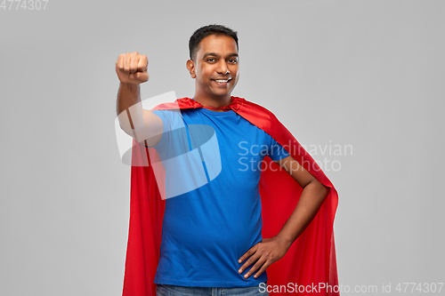 Image of indian man in superhero cape makes winning gesture