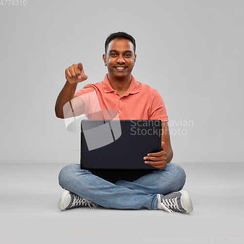 Image of happy indian man with laptop computer