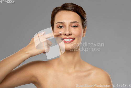 Image of beautiful smiling woman showing her nose