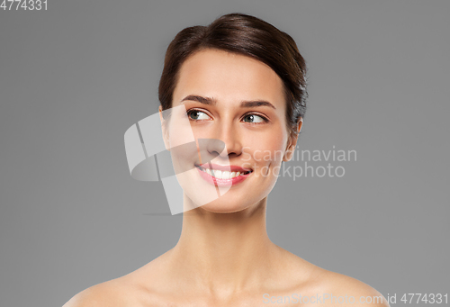 Image of beautiful smiling young woman with bare shoulder