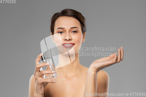 Image of happy woman with perfume