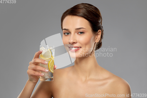 Image of woman drinking water with lemon and ice