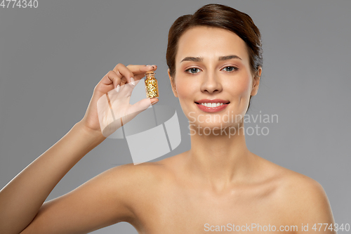 Image of beautiful young woman with gold facial mask