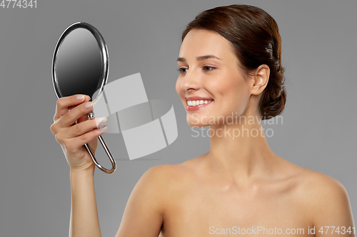 Image of beautiful young woman looking to mirror