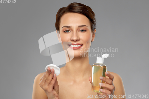 Image of young woman with toner or cleanser and cotton pad