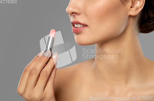 Image of beautiful smiling young woman with pink lipstick