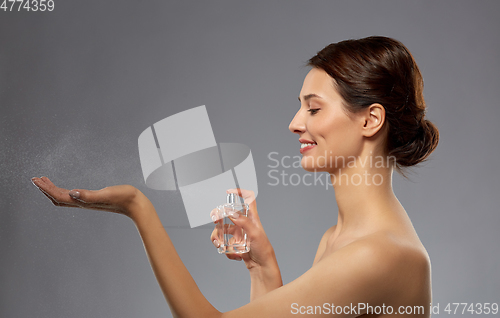 Image of happy woman with perfume