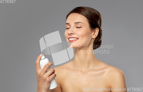 Image of beautiful young woman with facial spray or mist