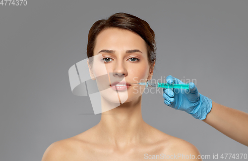 Image of beautiful young woman and hand with syringe