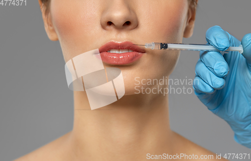 Image of beautiful young woman and hand with syringe