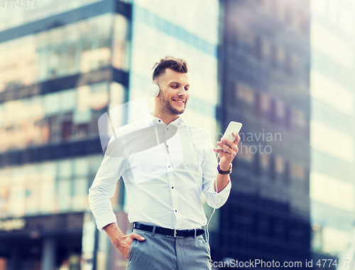 Image of man with headphones and smartphone listening music