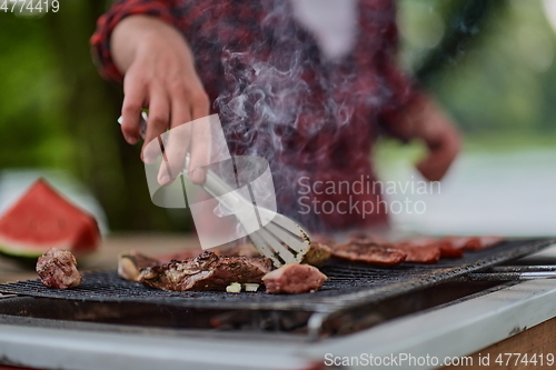 Image of man cooking tasty food for french dinner party