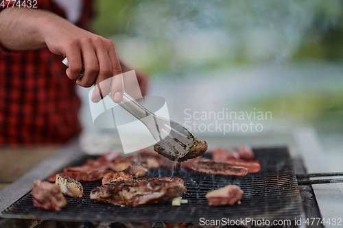 Image of man cooking tasty food for french dinner party