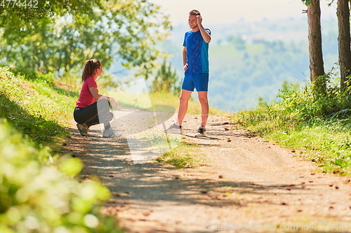 Image of couple enjoying in a healthy lifestyle while jogging on a country road