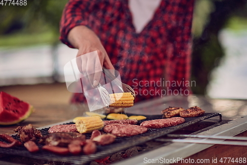 Image of man cooking tasty food for french dinner party