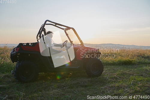 Image of man enjoying beautiful sunny day while driving a off road buggy car