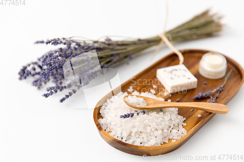 Image of sea salt with spoon and lavender on wooden tray