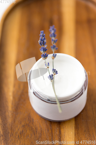 Image of close up of lavender moisturizer on wooden tray