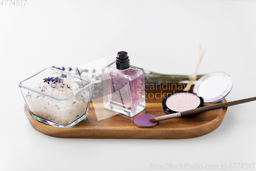 Image of sea salt, perfume and lavender on wooden tray