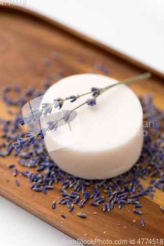 Image of close up of crafted lavender soap on wooden tray