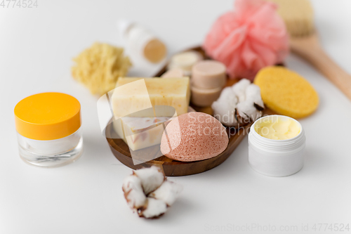 Image of crafted soap, sponge and wisp on wooden tray