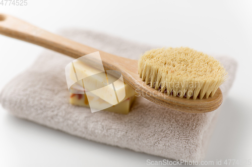 Image of crafted soap bars, natural brush and bath towel