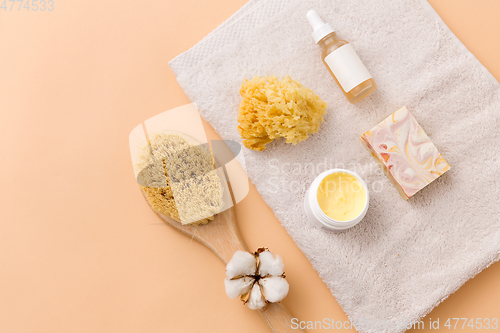 Image of soap, brush, sponge and body butter on bath towel