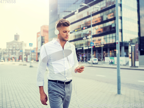 Image of man with headphones and smartphone listening music