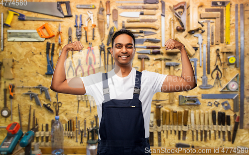 Image of smiling indian worker or builder showing his power