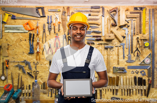 Image of happy indian builder in helmet with tablet pc