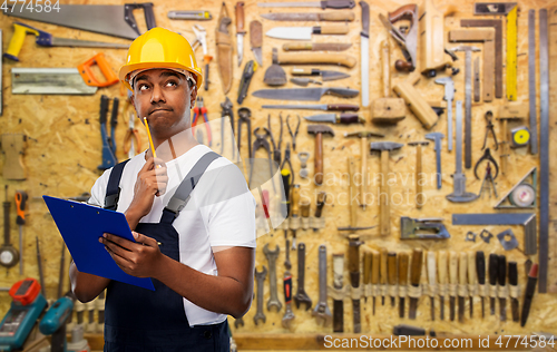 Image of thinking builder with clipboard and pencil