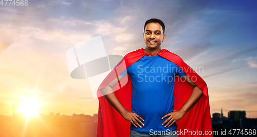 Image of happy smiling indian man in red superhero cape