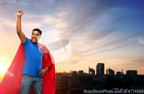 Image of indian superhero makes winning gesture in city