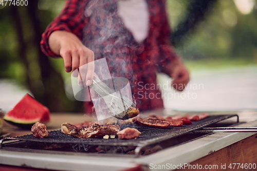 Image of man cooking tasty food for french dinner party